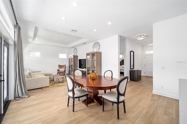 dining area featuring a raised ceiling