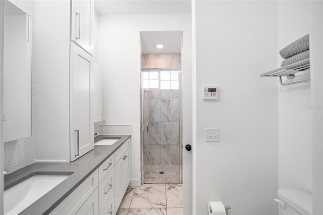 bathroom with vanity, an enclosed shower, and toilet