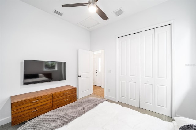 carpeted bedroom with a closet and ceiling fan