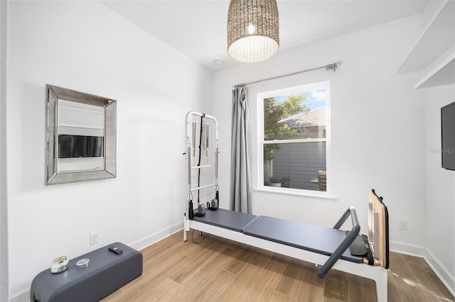 exercise room with wood-type flooring