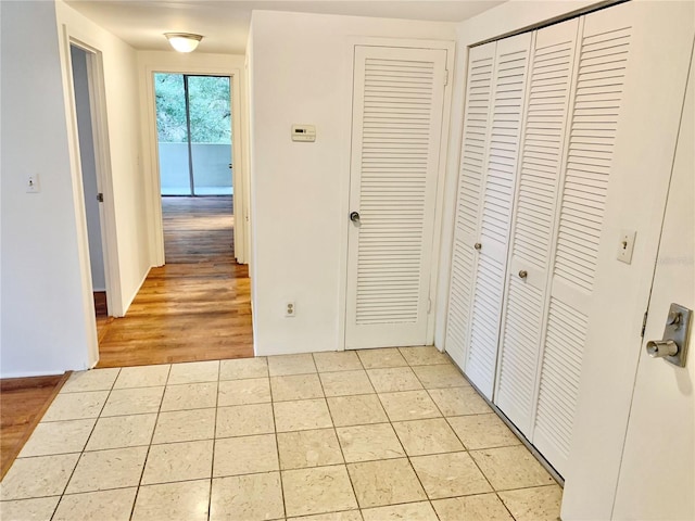 hallway featuring light tile patterned flooring