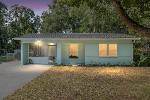 view of front of property with a porch and a yard