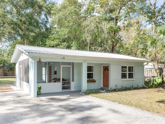 single story home featuring a carport and a front yard