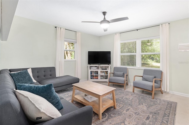 living room with ceiling fan and a wealth of natural light