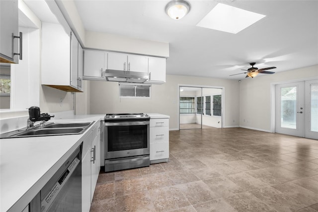 kitchen with electric stove, black dishwasher, a wealth of natural light, white cabinets, and french doors