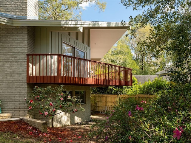 back of property with fence and brick siding