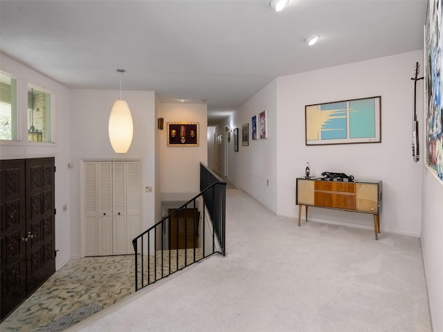 carpeted entryway with baseboards