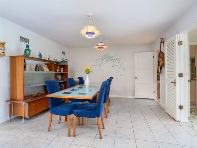 dining area featuring visible vents, baseboards, and light tile patterned floors