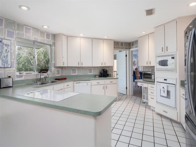 kitchen featuring white appliances, tasteful backsplash, a toaster, a sink, and light tile patterned flooring