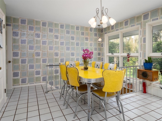 dining space with plenty of natural light, a chandelier, and light tile patterned flooring