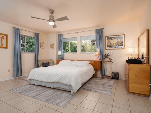 bedroom featuring light tile patterned flooring, baseboards, and multiple windows