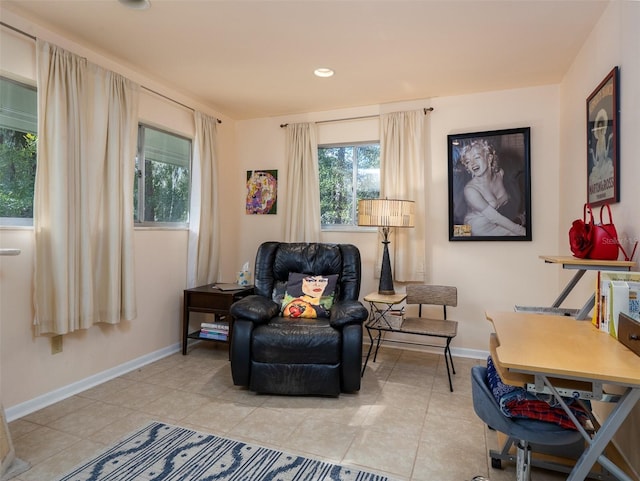 living area with recessed lighting, baseboards, and light tile patterned flooring