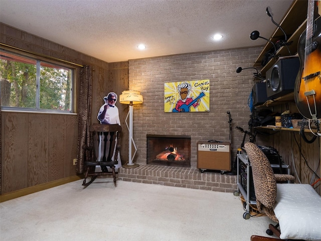 living area featuring a textured ceiling, a brick fireplace, carpet flooring, and heating unit