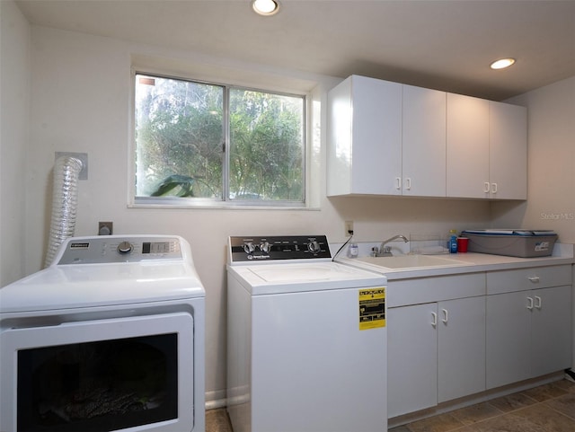 clothes washing area featuring independent washer and dryer, a sink, cabinet space, and recessed lighting