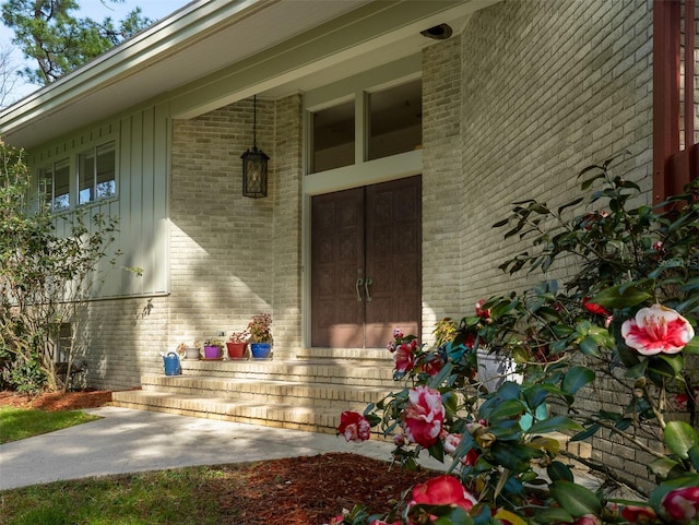 entrance to property featuring brick siding