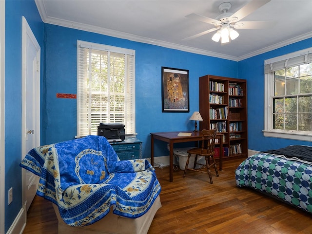 living area with ornamental molding, ceiling fan, baseboards, and wood finished floors