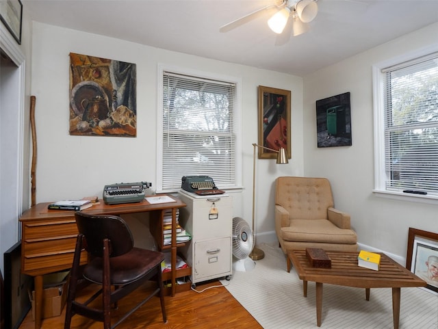 office area featuring ceiling fan, baseboards, and wood finished floors