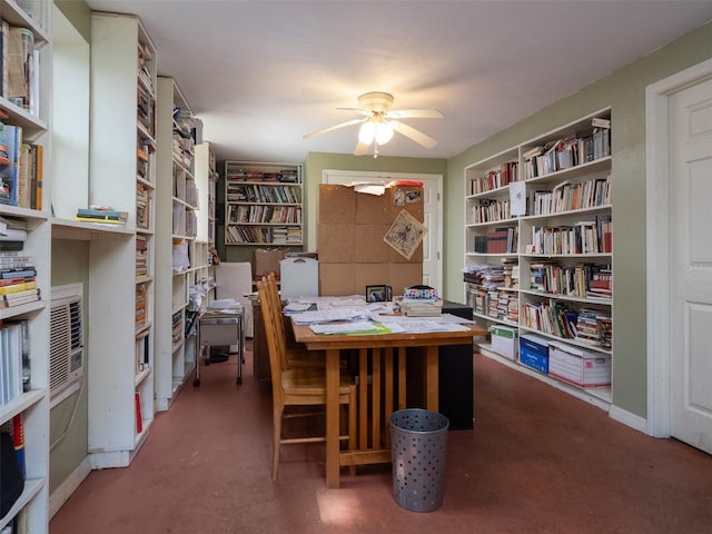 home office featuring concrete flooring and a ceiling fan