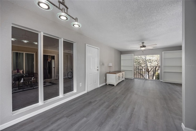 interior space featuring hardwood / wood-style flooring, ceiling fan, and a textured ceiling