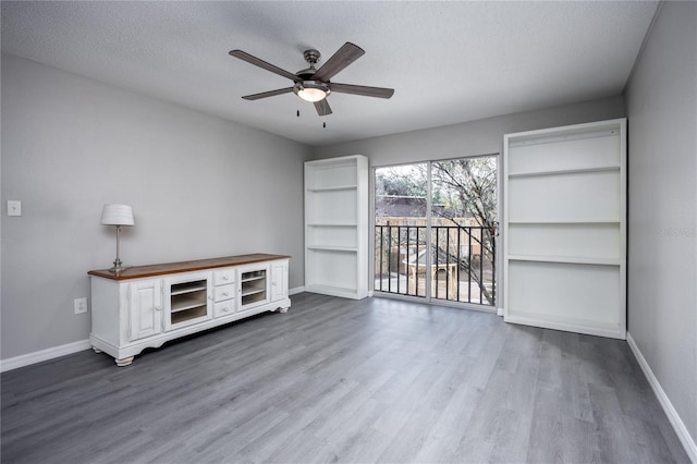 interior space featuring ceiling fan, hardwood / wood-style floors, and a textured ceiling