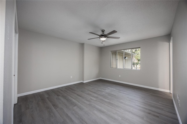 unfurnished room featuring a textured ceiling, dark hardwood / wood-style floors, and ceiling fan