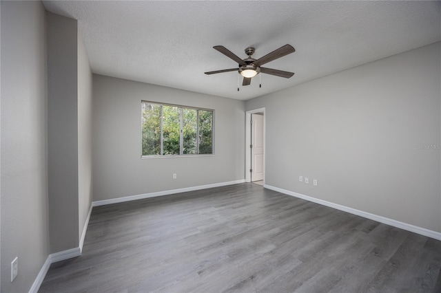 unfurnished room with ceiling fan, a textured ceiling, and dark hardwood / wood-style flooring