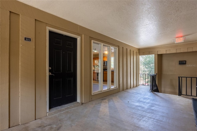 interior space featuring concrete floors and a textured ceiling