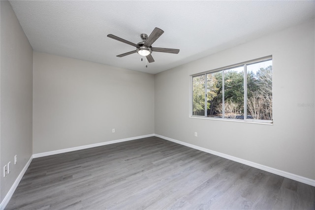 spare room with wood-type flooring, a textured ceiling, and ceiling fan