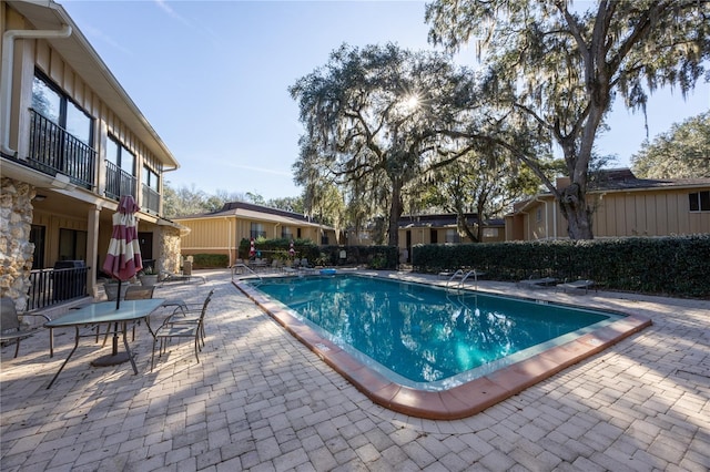 view of swimming pool with a patio