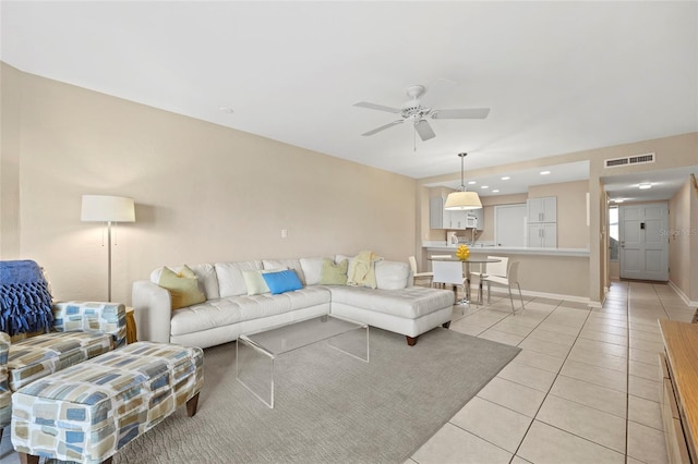 tiled living room with ceiling fan