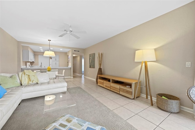 tiled living room with ceiling fan