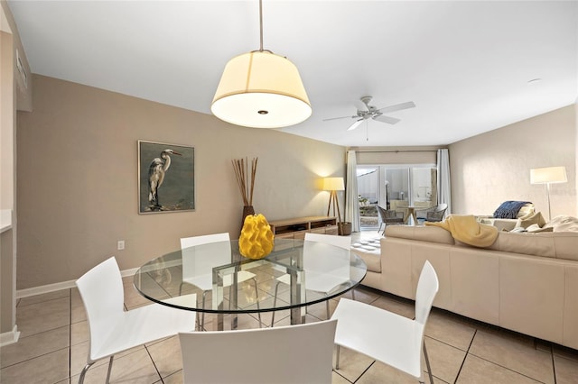 tiled dining area featuring ceiling fan