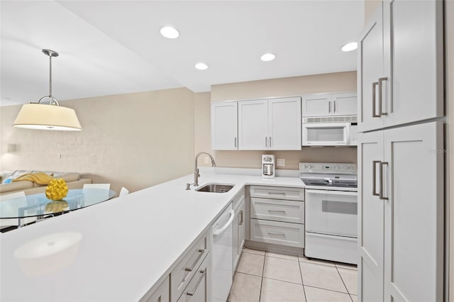 kitchen with sink, hanging light fixtures, light tile patterned floors, white appliances, and white cabinets