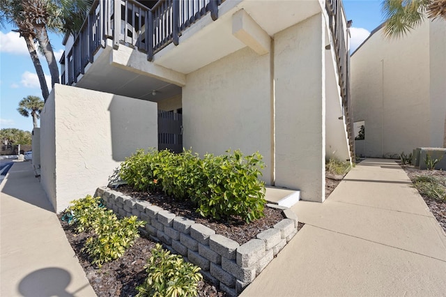 view of side of home featuring a balcony