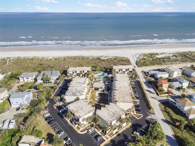 drone / aerial view with a water view and a beach view