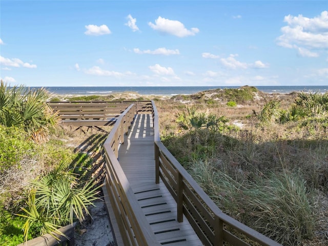 surrounding community with a water view and a view of the beach