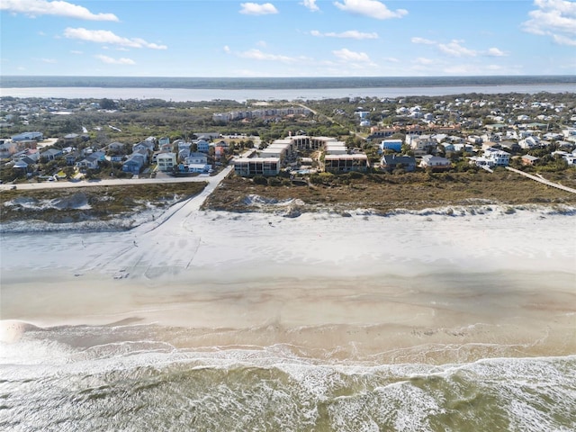 drone / aerial view with a water view and a view of the beach