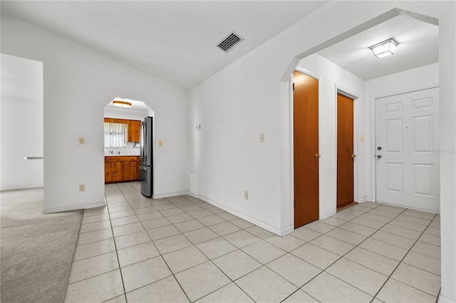 tiled spare room with lofted ceiling