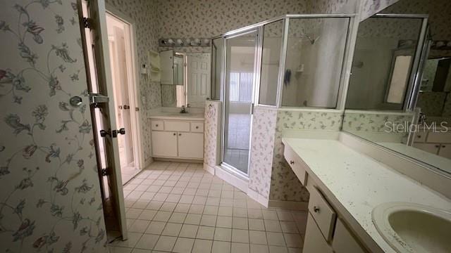 bathroom featuring vanity, tile patterned floors, and a shower with shower door