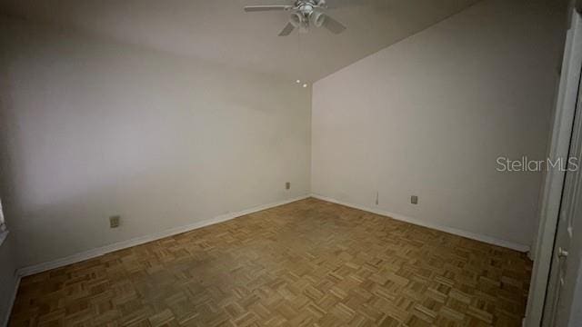 unfurnished room featuring ceiling fan and dark parquet floors