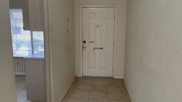 doorway featuring light tile patterned floors