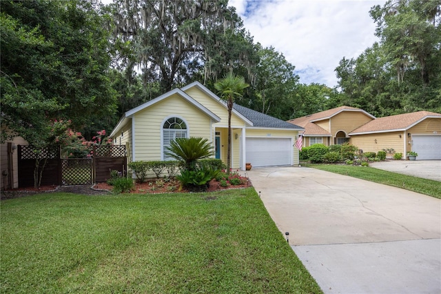 ranch-style home with a garage and a front lawn