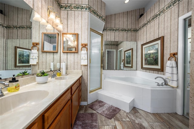 bathroom with vanity and shower with separate bathtub