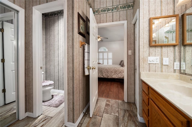 bathroom featuring vanity, ceiling fan, and toilet