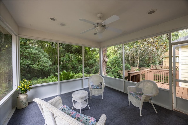 sunroom / solarium featuring plenty of natural light and ceiling fan