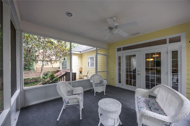 sunroom / solarium featuring french doors and ceiling fan