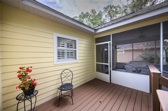 deck featuring a sunroom and ceiling fan