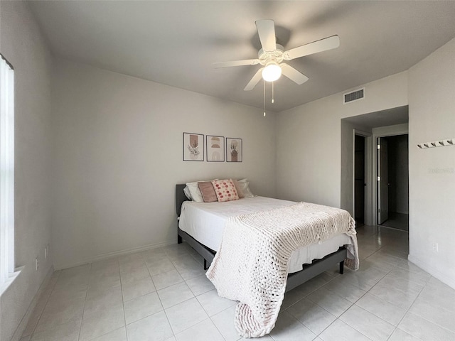 bedroom with ceiling fan and light tile patterned floors