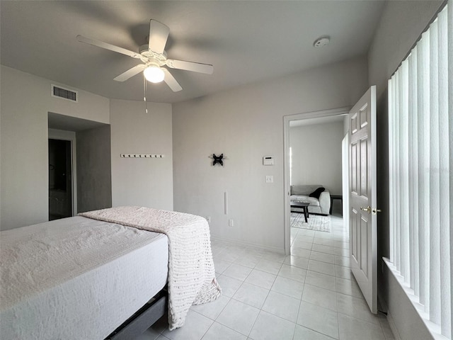 tiled bedroom with ceiling fan