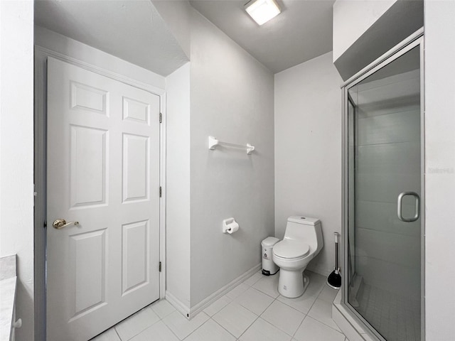 bathroom with tile patterned flooring, toilet, and walk in shower